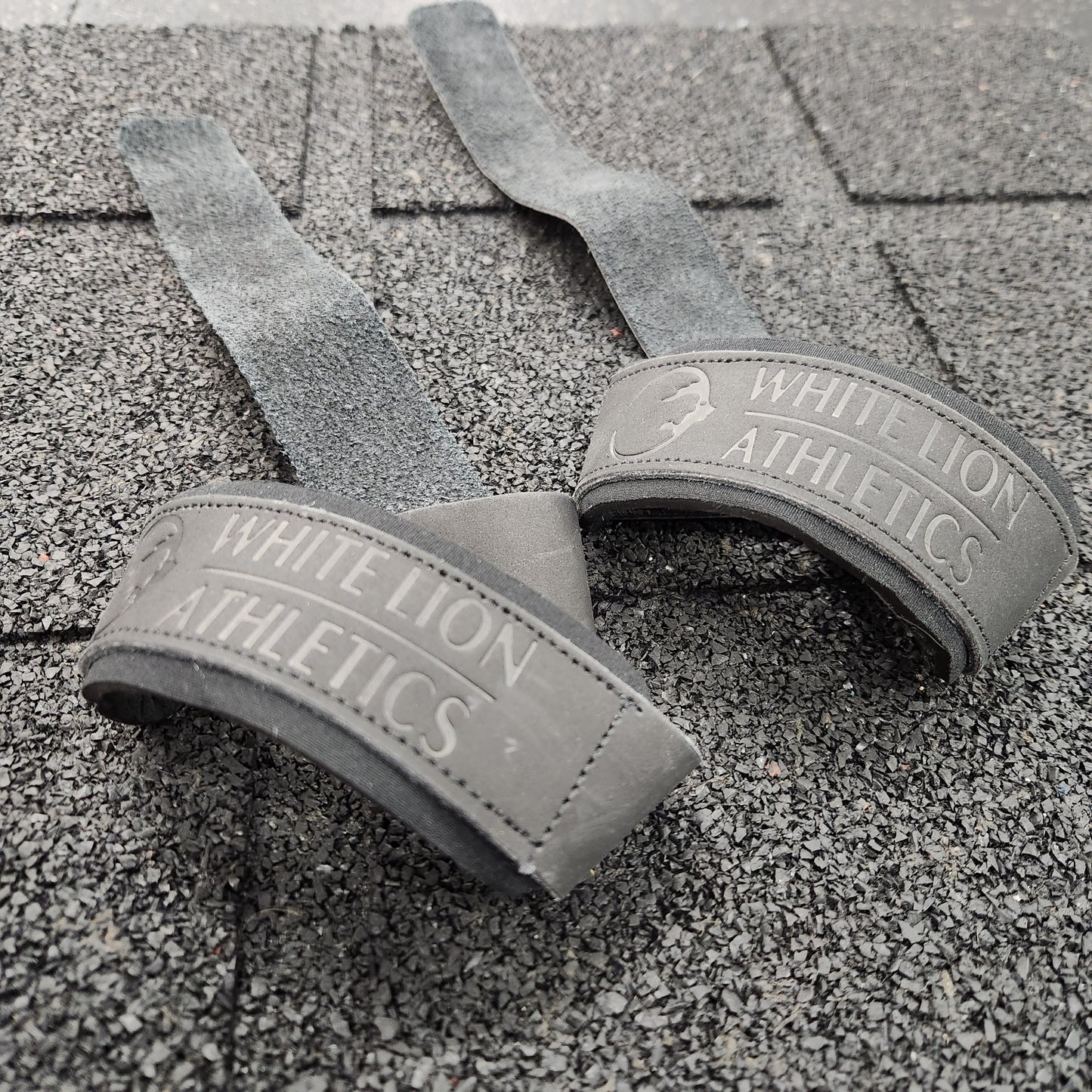 Close up shot of a pair of black leather weights straps by White Lion Athletics.