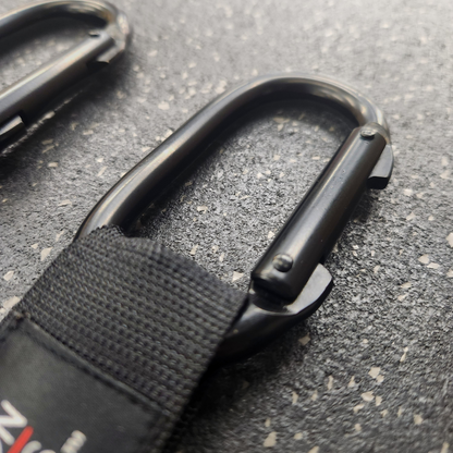 Close-up shot of the heavy duty , black carabiner on the White Lion Athletics competition straps for gymnastics rings.