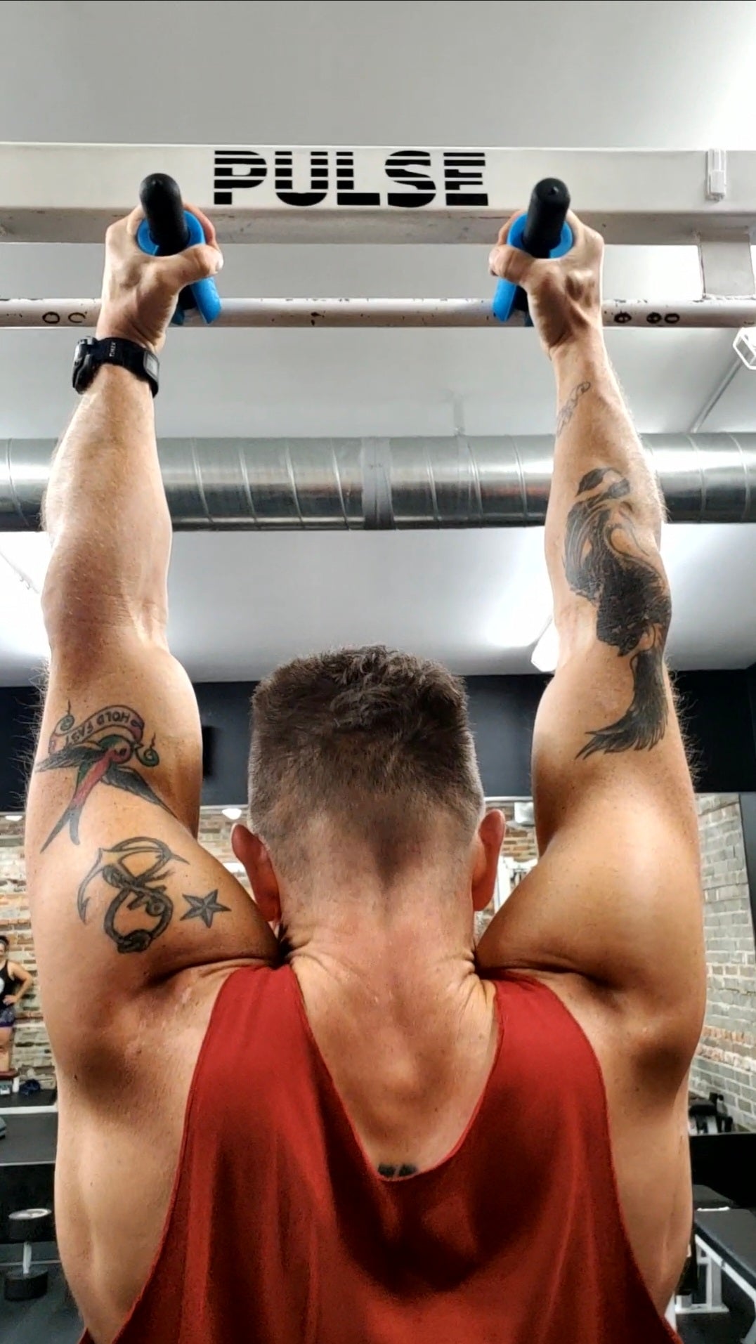 man doing  pull-ups using White Lion Athletics Grip Sleeves