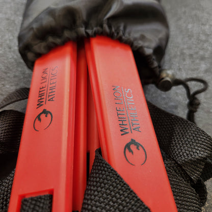 Close-up photot of the black logos on the red rungs of a 6 meter agility ladder by White Lion Athletics. Ladder is pictured in it's black drawstring carrybag.