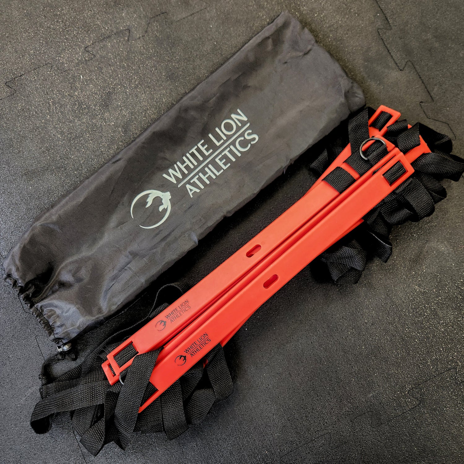 6 meter agility ladder by White Lion Athletics. Red rungs with heavy duty black nylon webbing and black, drawstring carrying bag.
