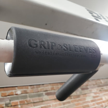 2.25" Grip Sleeves for grip strength training placed on pull-up bar.