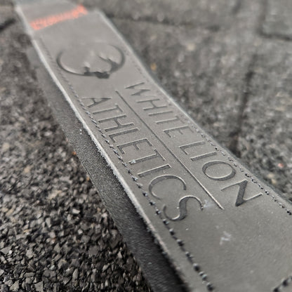 Close up shot of embossed logo on leather weightlifting straps by White Lion Athletics.
