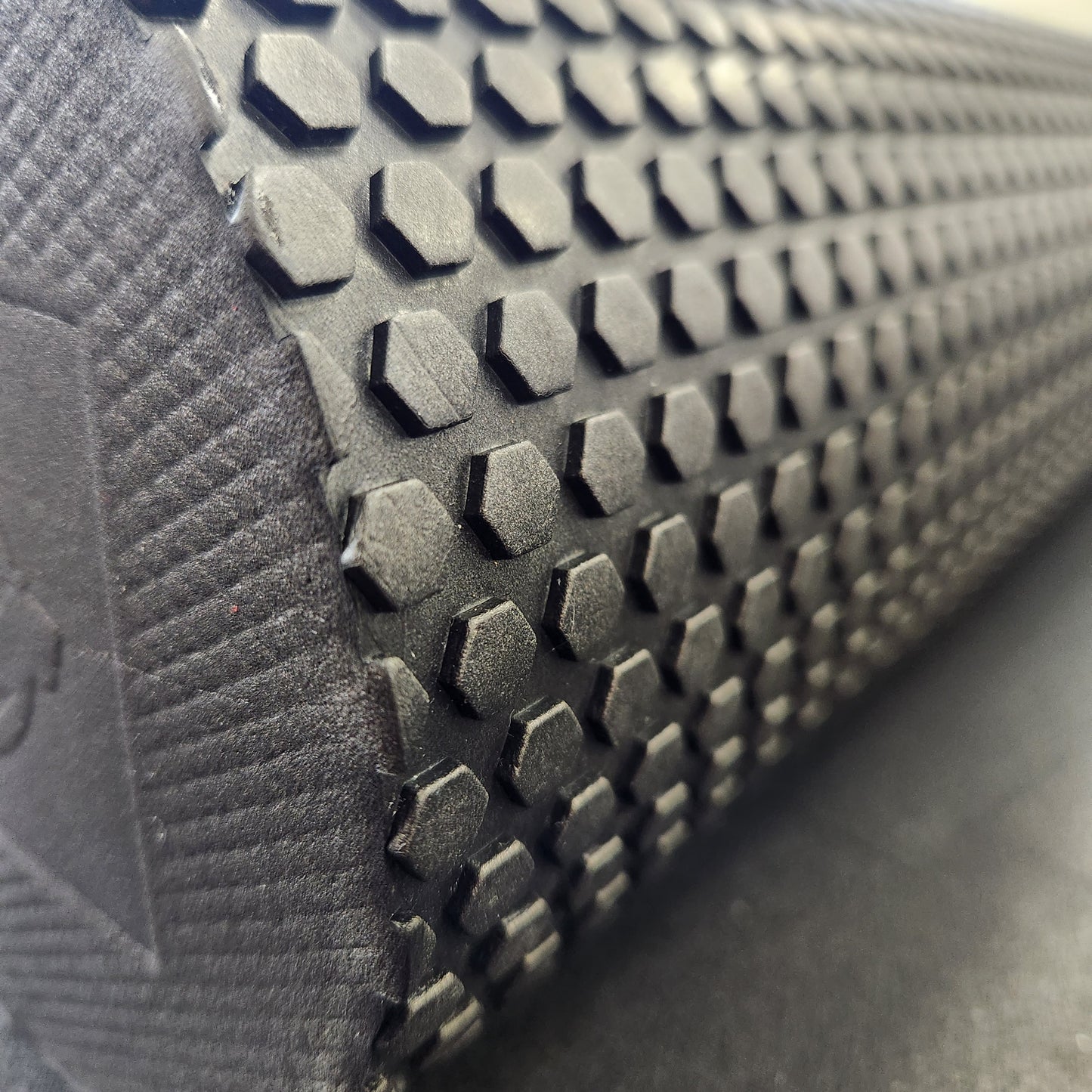 Close-up shot of the grid pattern on the 18" High Density EVA Foam Roller by White Lion Athletics