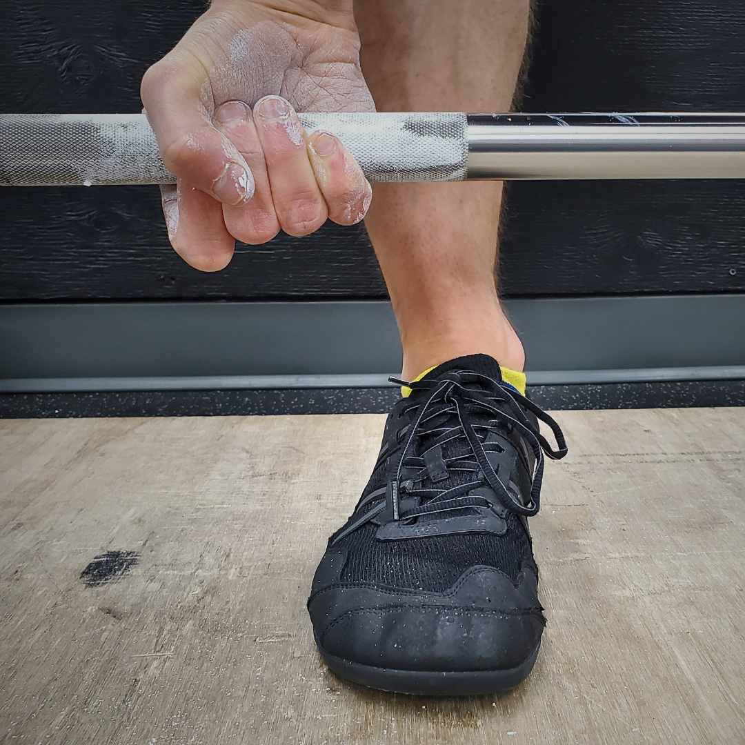 Gym chalk by White Lion athletics being used on hands while training with a barbell.